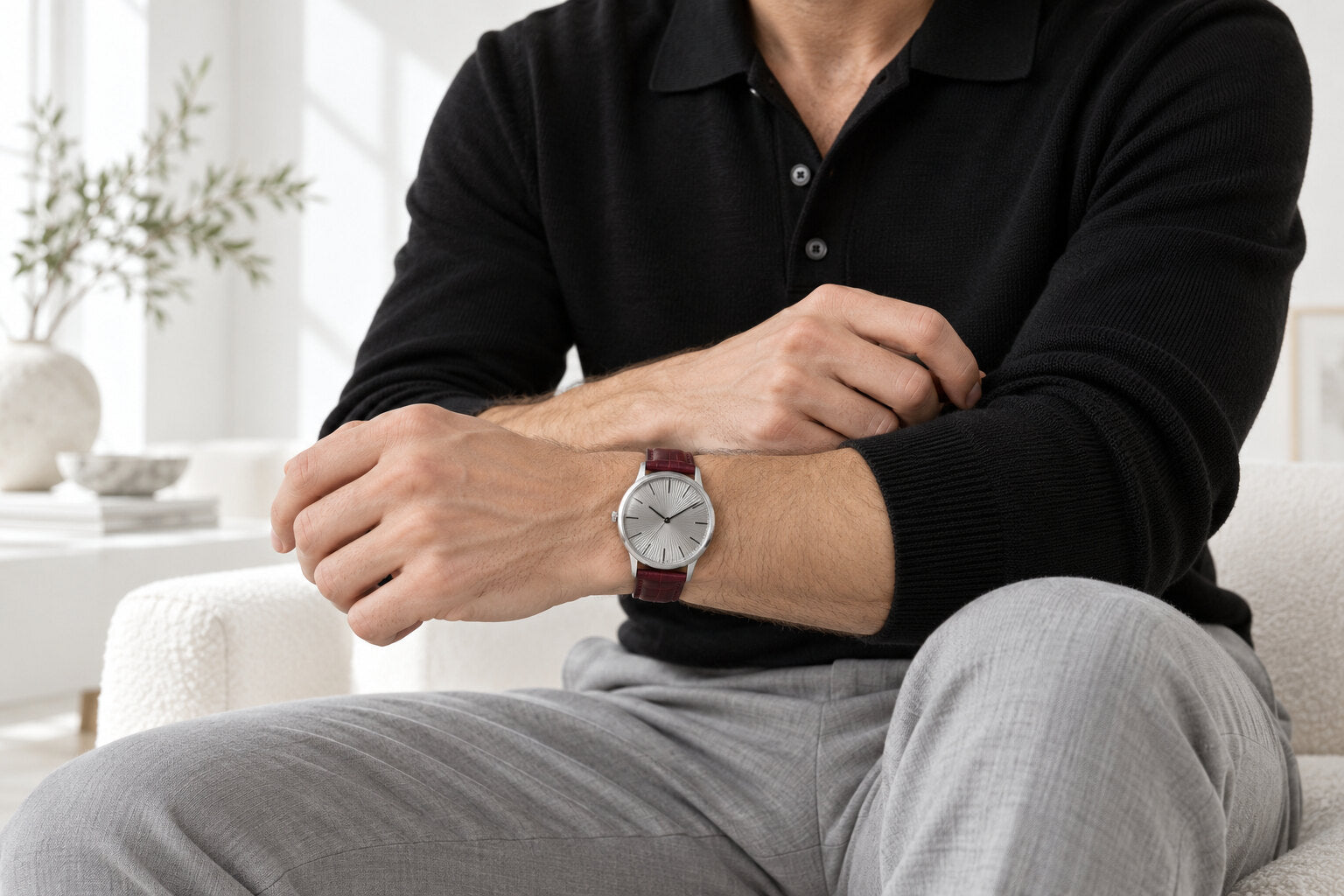 Ellington watch worn with a black knit polo